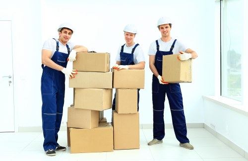 Professional movers handling office equipment